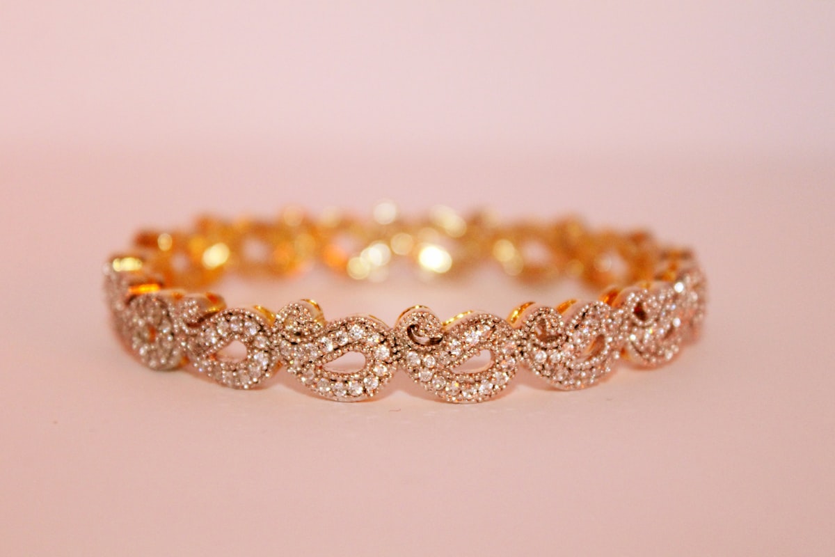 Hands wearing fine rings and bracelets